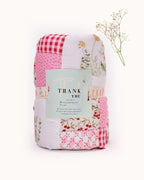 laad`s girl wearing white Rabit quilt features playful rabbits & vibrant scarlet for a touch of magic. Soft cotton & cozy fiber filling for ultimate comfort. 