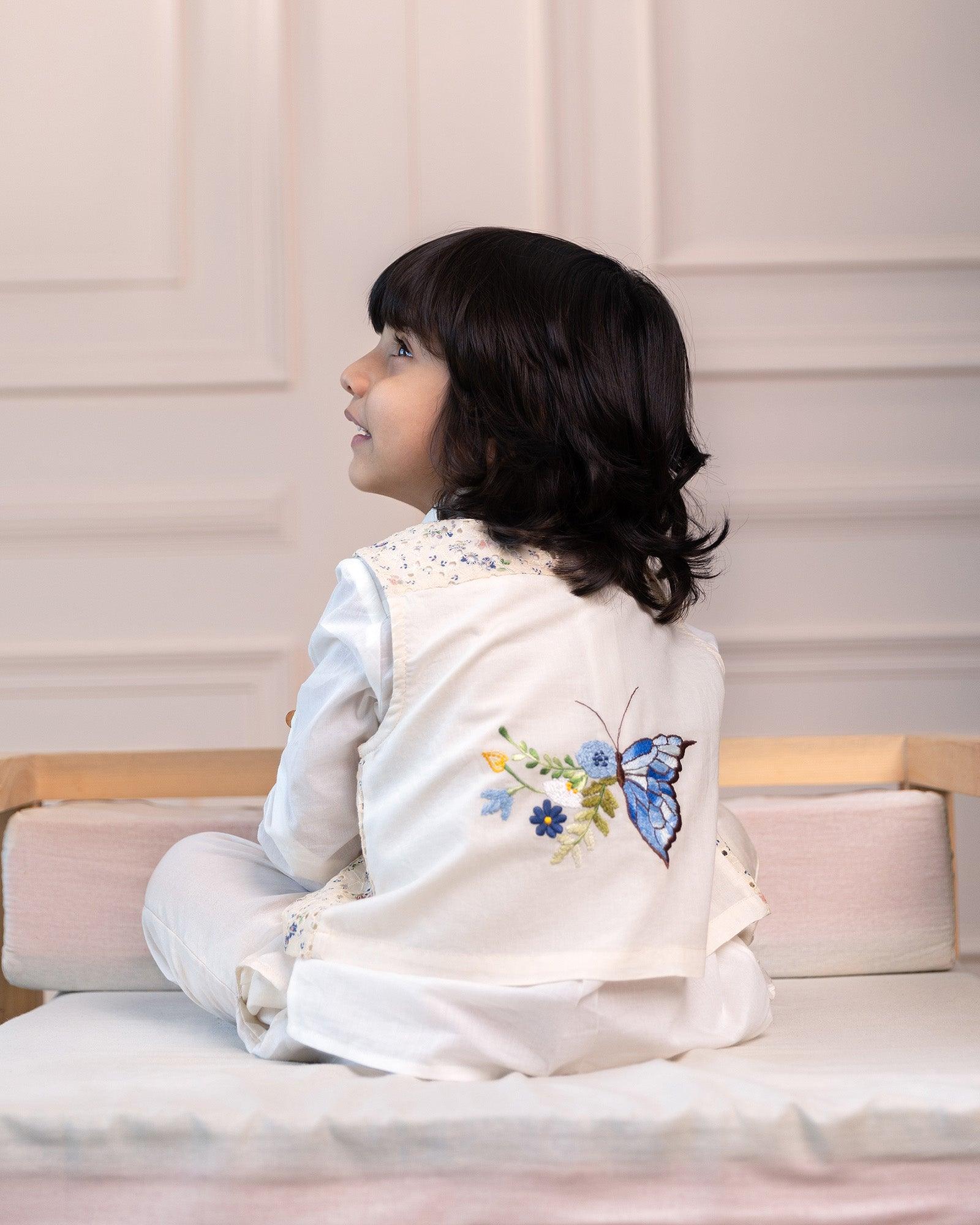 3-piece white ball suit set from laadindia ! Crisp cotton shirt, 100% cotton waistcoat with intricate details & silk Chanderi pyjama. Hand-embroidered, titalee motif adds charm.