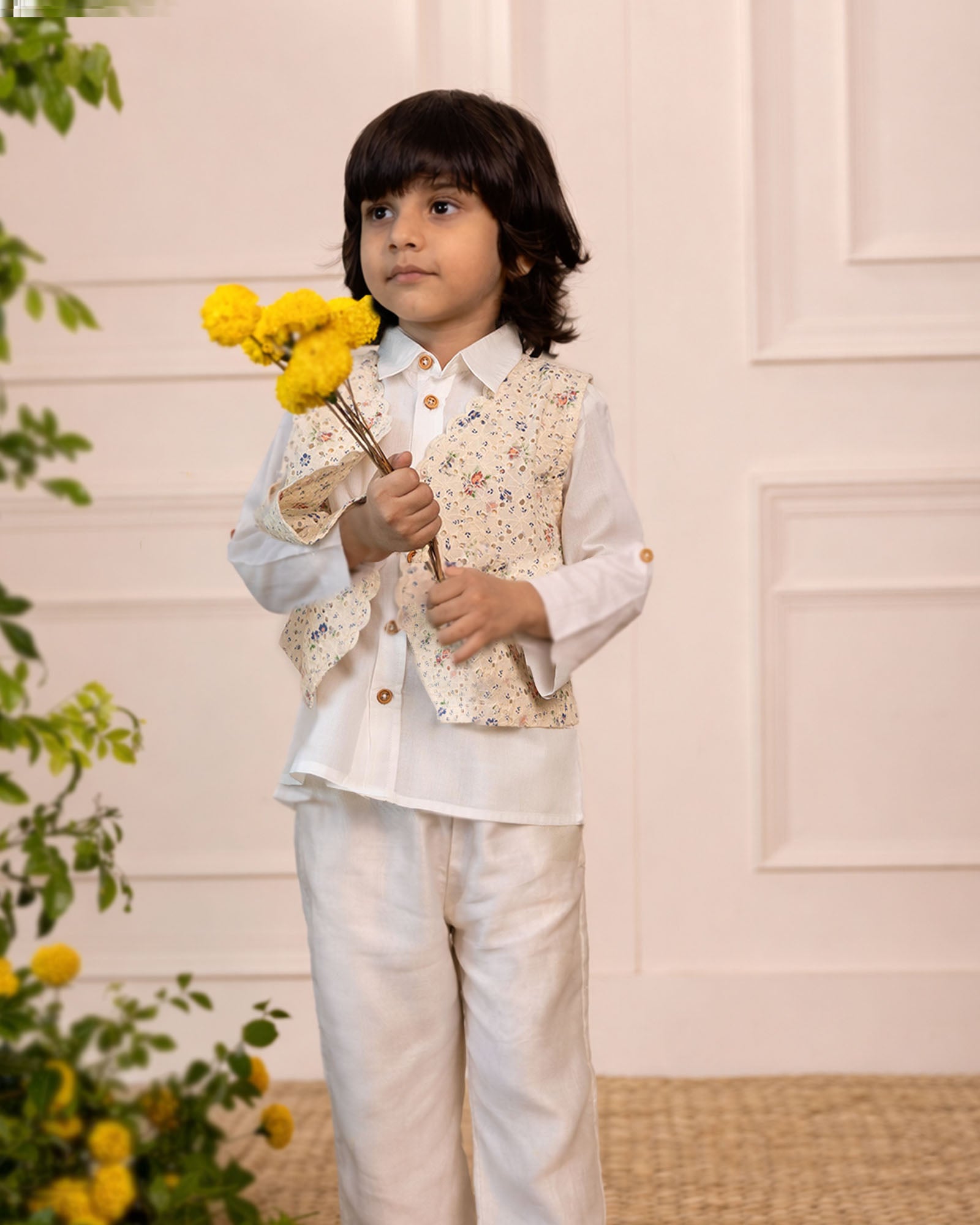 laad`s kid in Classic white cotton shirt  paired with a 100% cotton waistcoat with butterfly embroidery at the back . Perfect boy`s party wear