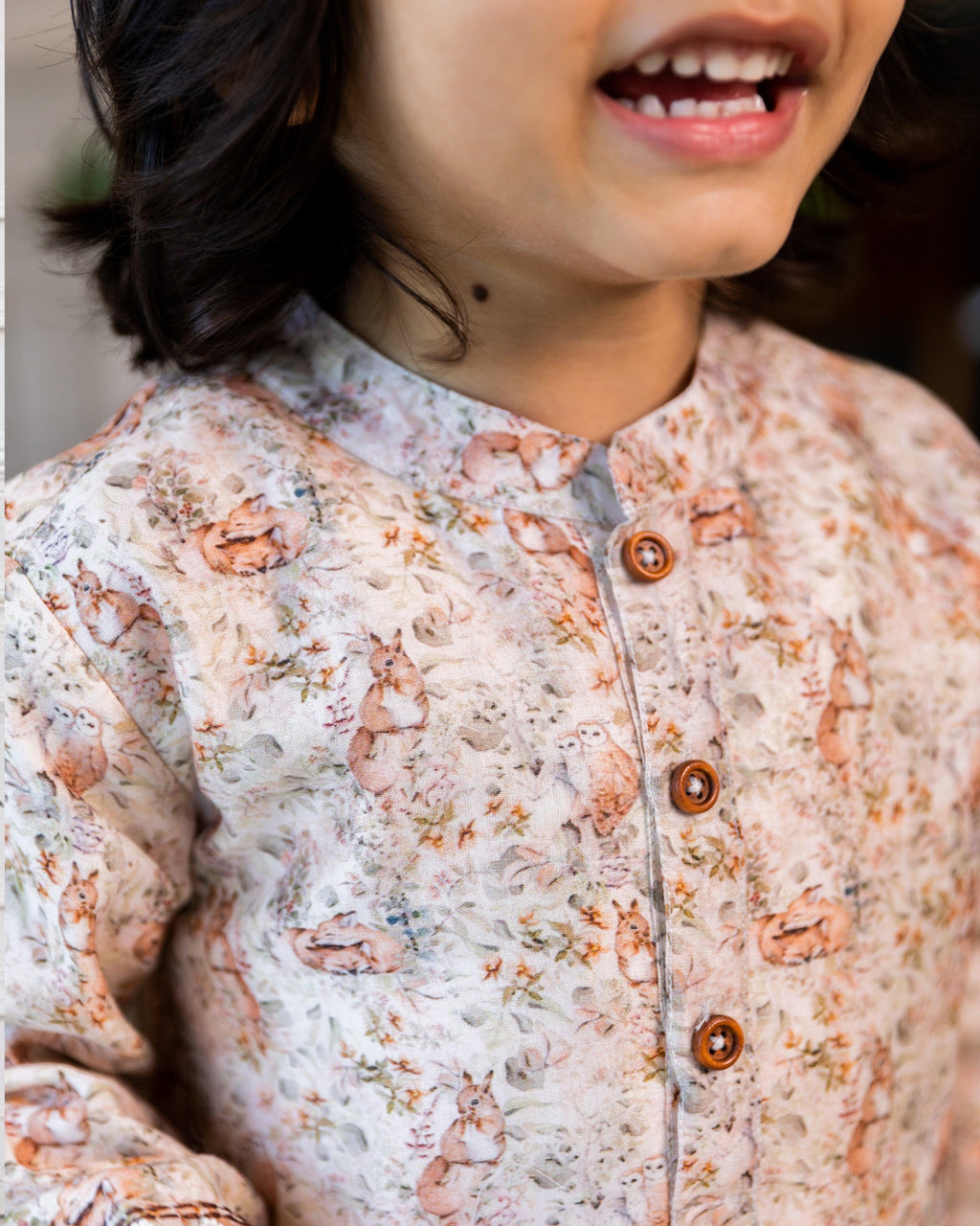 laad`s kid wearing a long-sleeved woodland print kurta with intricate nature-inspired motifs, paired with white pyjama. perfect for festive or special occasions