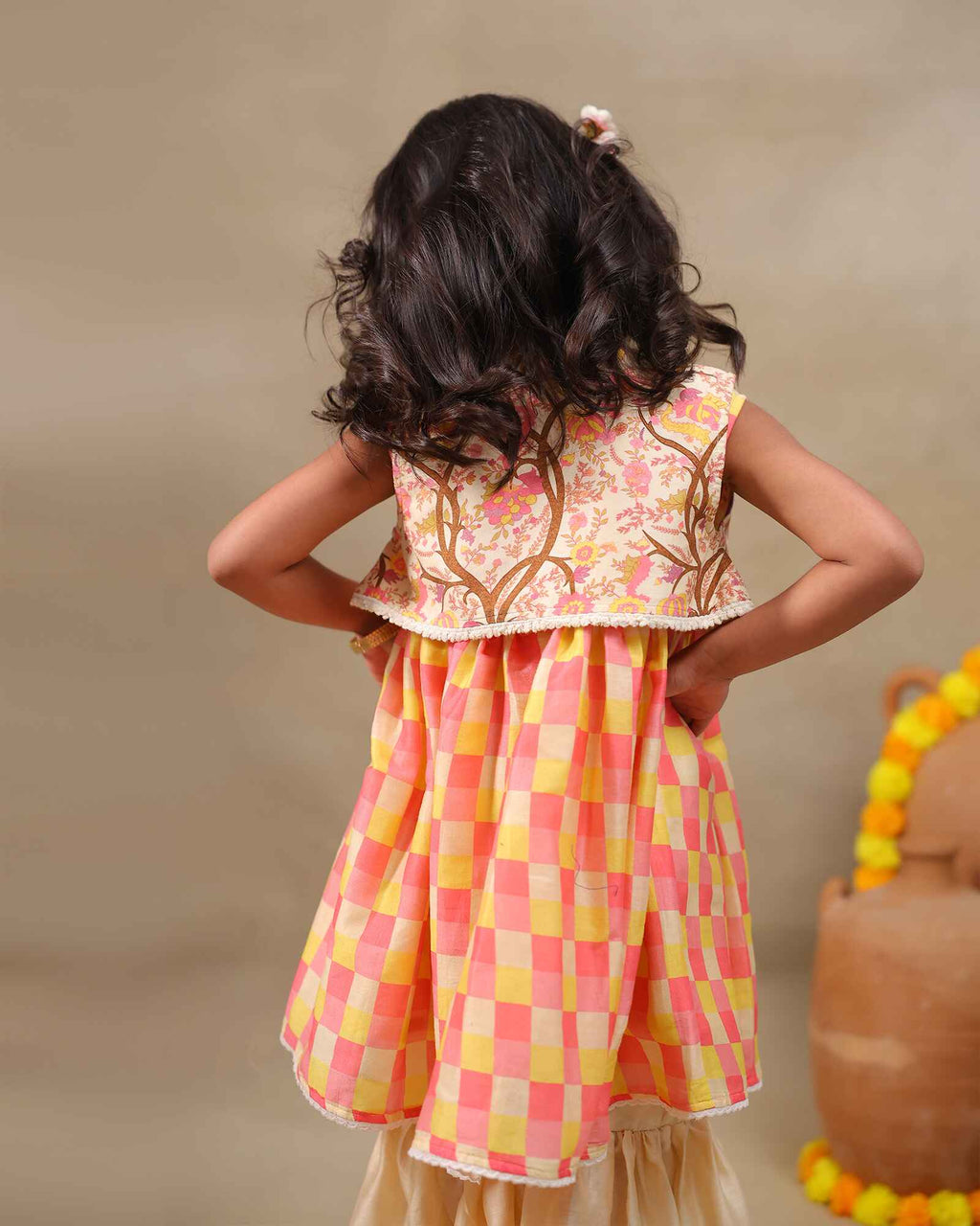 Girl wearing the Zinnia Sharara with jacket , featuring a vibrant checkered sharara party wear with embroidery  perfect for festive occasions , pooja , occasion wear and  weaddings 