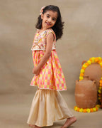 Girl wearing the Zinnia Sharara with jacket , featuring a vibrant checkered sharara party wear with embroidery  perfect for festive occasions , pooja , occasion wear and  weaddings 
